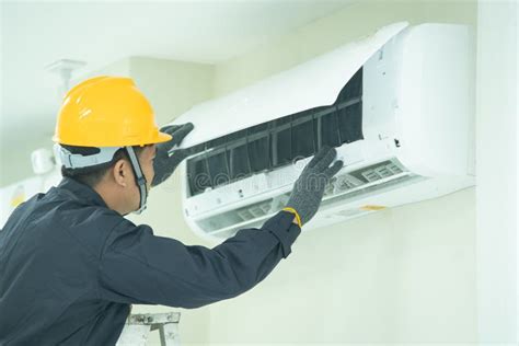 The Mechanic Technician Are Repairing Air Conditioner Stock Photo