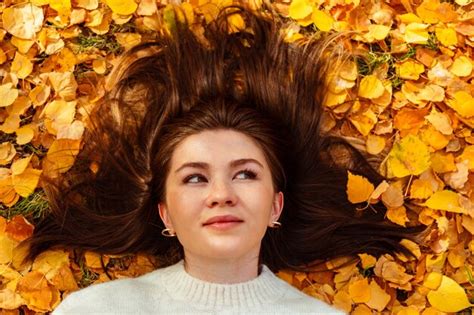 Premium Photo Woman Laying On Yellow Autumn Leaves