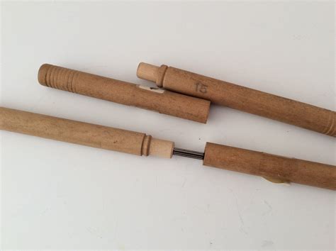 Two Wooden Knitting Needle Holders And Five Steel Knitting Needles