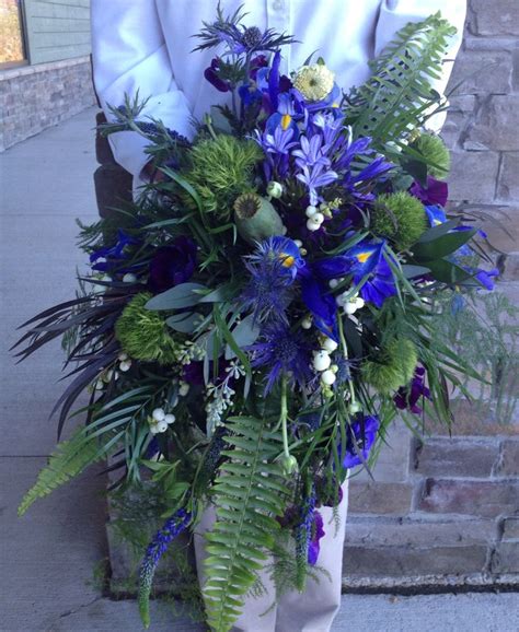 A queensland researcher has solved a floral mystery, and as a result, a variety of native australian fern is now being used in wedding bouquets all around the world. cascading blue wedding bouquet with thistle, agapanthus ...