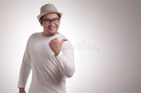 Young Man Showing And Pointing Something On His Side Stock Photo