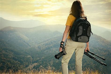 Professional Photographer With Modern Camera And Tripod In Mountains