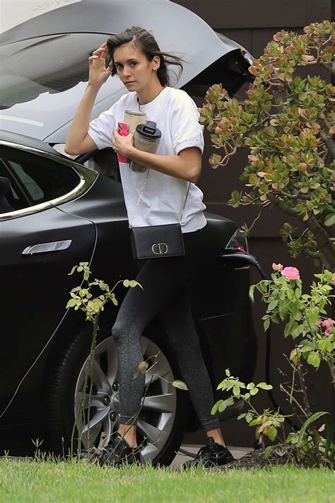 Nina Dobrev Spotted In A White Tee And Black Leggings While Rushing Out