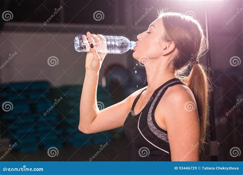 Fitness Woman Drinking Water From Bottle Muscular Young Female At Gym