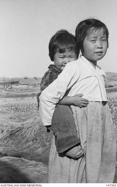 Korea 1951 04 A Young Korean Girl Giving Her Younger Sister A Ride On