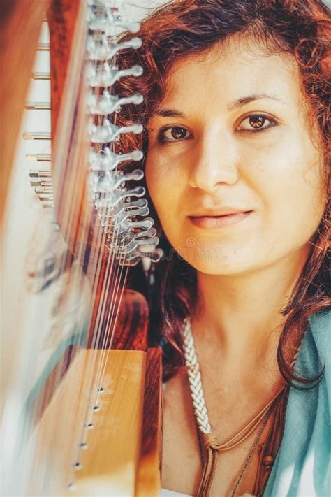 Woman With A Harp Beautiful Girl Harpist Playing Her Instrument Stock