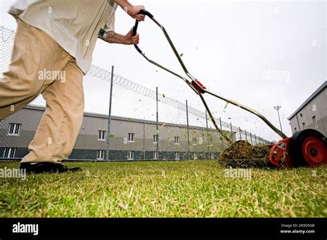 Inmate and push mower Stock Photo - Alamy