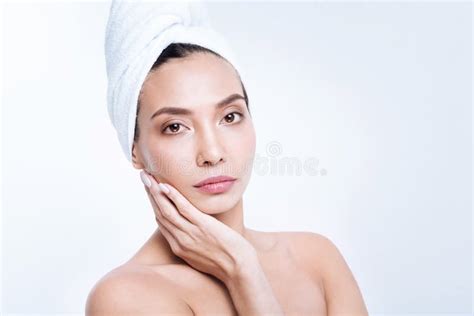 Pleasant Woman In Towel Turban Cupping Her Cheek In Hand Stock Image