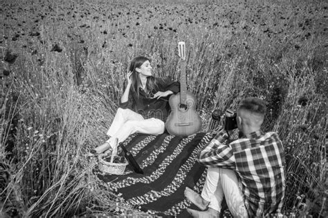 Couple In Love Making Photo On Camera With Acoustic Guitar In Summer Poppy Flower Field Free