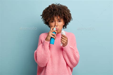 Portrait Of Displeased Afro American Woman Sniffs Nasal Aerosol Feels Sick Has Running Nose