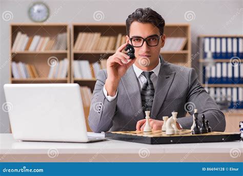 The Young Businessman Playing Chess In The Office Stock Photo Image