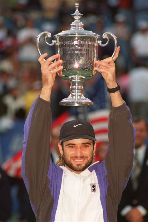 Andre Agassi Holds Up The Trophy After Defeating Michael Stich In The