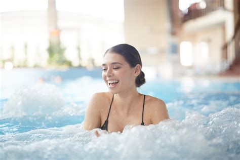 Beautiful Woman Enjoying Bubbles In Hot Tub Pool Clinic