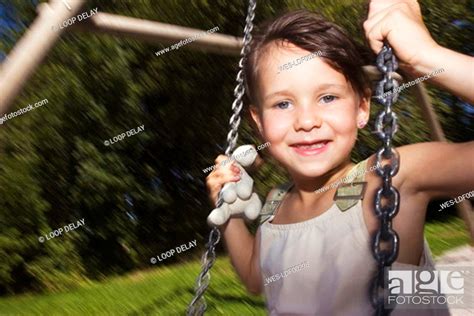 Girl Sitting On Swing Smiling Stock Photo Picture And Royalty Free Image Pic WES