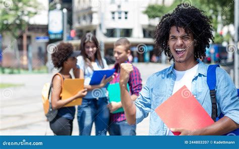 Successful Hispanic Male Student With Other Young Adults Stock Image