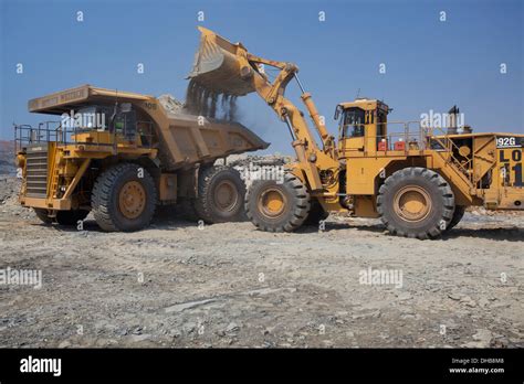 Action Shot Of A Front End Loader Filling A Large Haul Dump Mine Stock