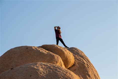 Free Stock Photo Of Man Photographing From Top Of Rock Formation