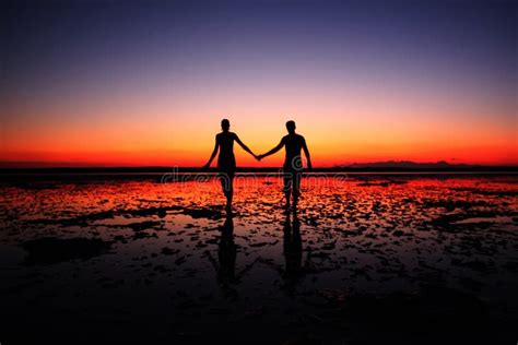 Young Couple Holding Hands On Sunset Sky Background Stock Image Image