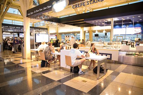 Passengers In Airport Food Court Using Their Computer Electronics Stock