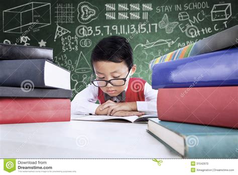 How we approach situations and the things we do to feed our brains can significantly improve our mental horsepower. Close-up Boy Student Reading Books In Class Stock Photo ...