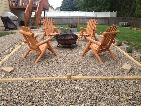 Pea Gravel Fire Pit With Landscape Timbers And Cedar Log Adirondack