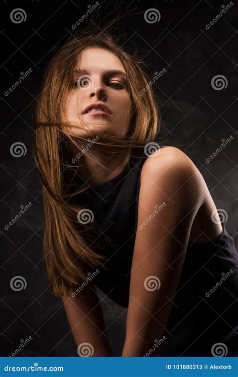 The Naked Sensual Girl Covering Her Breast By A Vest Stock Image