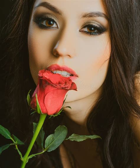 woman lips with red lipstick and beautiful red rose attractive woman holding red rose and