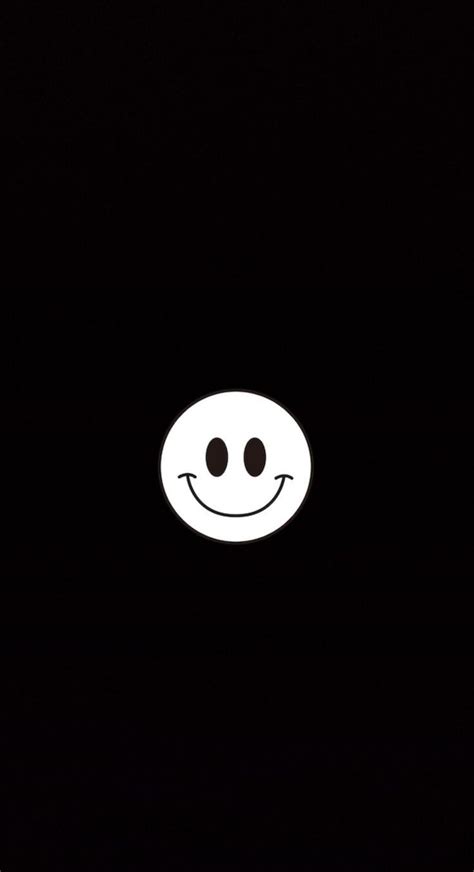 A Smiley Face Is Shown In The Dark