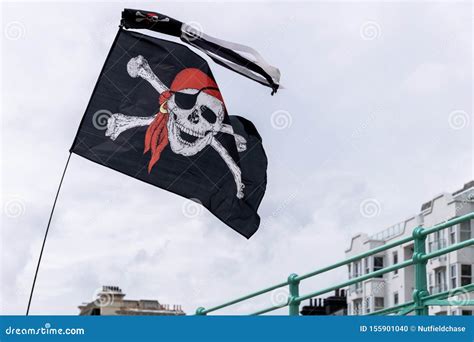 Jolly Roger Flag Flying In The Wind Above Brighton Sea Front Editorial