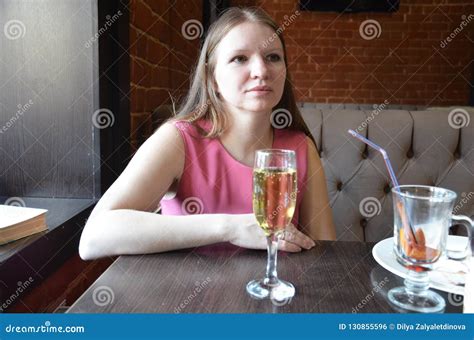 Beautiful Blond Girl Holding A Glass Of Champagne Or Wine Drinking