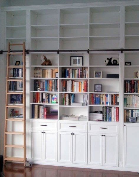 Library ladders, which are rolling or sliding ladders that hang on a rail to provide access to high shelves, lend such a refined, polished air to the room they occupy. #Shelves #ladder Library in White with Sliding Ladder ...