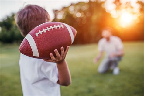 Dad With Son Playing American Football Stock Photo Download Image Now