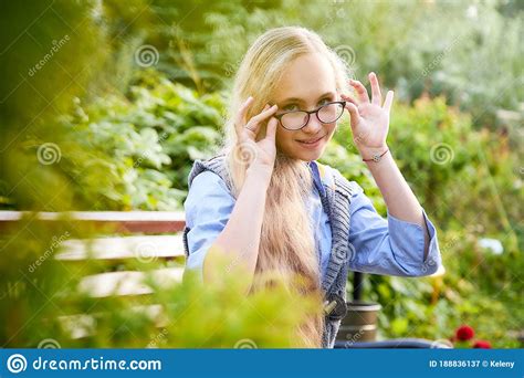 Pretty Teenage Girl 14 16 Year Old With Curly Long Blonde Hair And In Glasses In The Green Park
