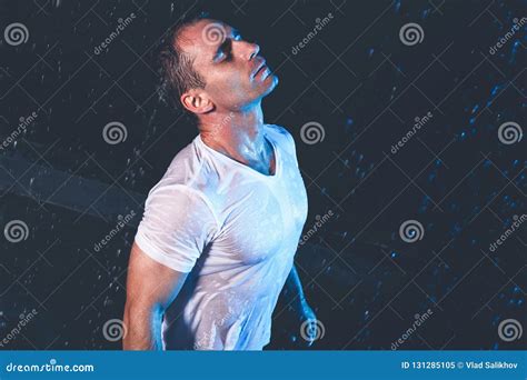 Fresh Portrait Of Muscular Man With Water Splashes On Dark Background