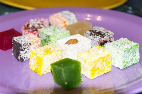 Many Assorted Multicolored Turkish Delight On Purple Background Stock