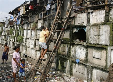 Residents Climb Into Their Houses Atop Gravestones Inside A Cemetery In Manila October 21 2008