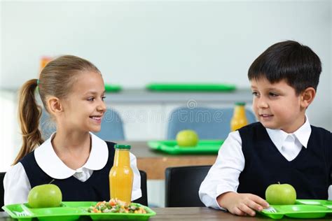 Children Eating Healthy Food For Lunch In School Canteen Stock Photo