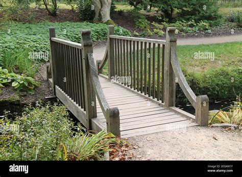 A Small Wooden Foot Bridge Across A Garden Stream Stock Photo Alamy