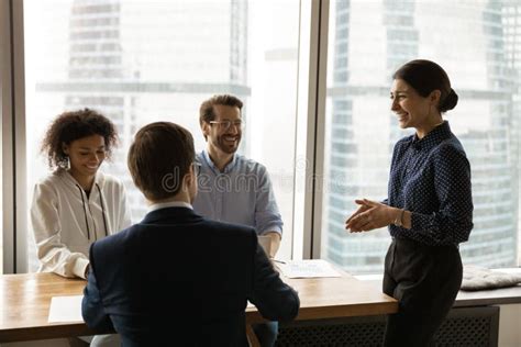 Indian Female Boss Lead Meeting With Diverse Colleagues Stock Photo