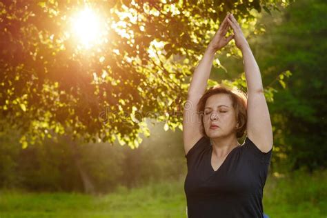 adult woman meditates with folded palms in the park with closed eyes stock image image of