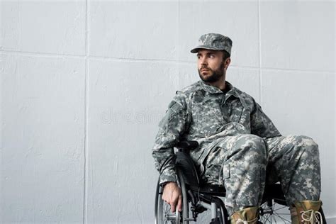 Disabled Military Man In Uniform Sitting In Wheelchair And Covering