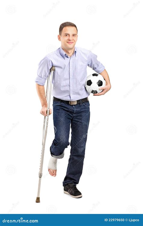 Injured Young Man On Crutches Holding A Ball Stock Photo Image 22979650