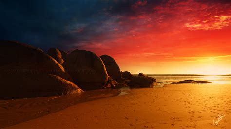 Brown Rock Formation Near Ocean Water During Orange Sunset Beach Sand