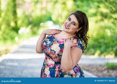 happy plus size fashion model in floral dress outdoors beautiful fat woman with beauty makeup