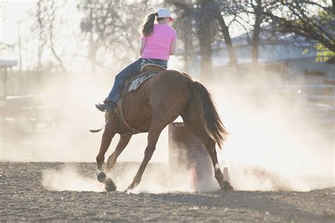 A Young Woman Practices Barrel Racing With Her Horse By Stocksy