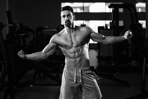 Muscular Man Flexing Muscles In Gym Stock Image Image Of Conscious