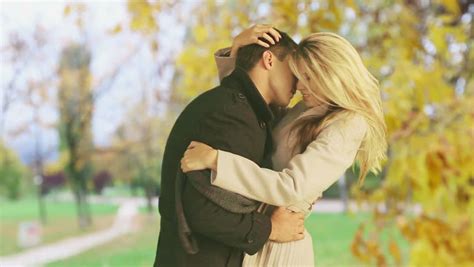 Man And Woman Kissing Madly Beautiful In Autumn Park She Leans Back