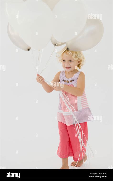 Girl Holding Balloons Stock Photo Alamy