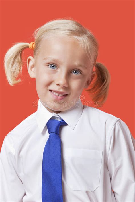 Portrait Of A Cute Young Girl In School Uniform Over Blue