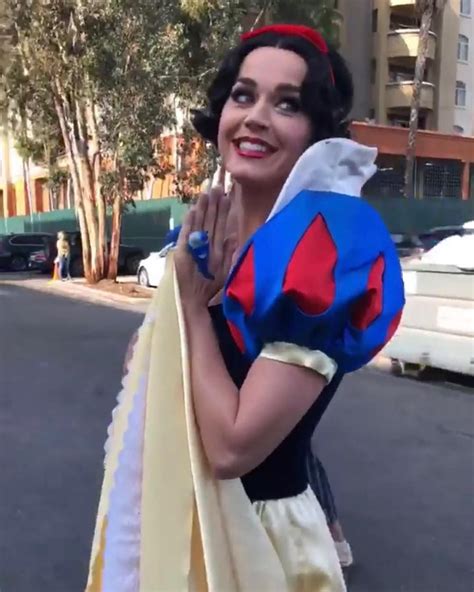 A Woman Dressed As Snow White Standing In The Street